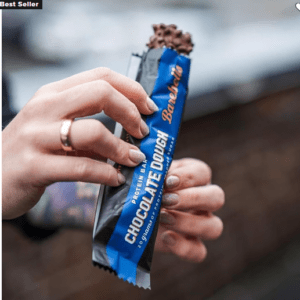 A man with layer protein bar in hand